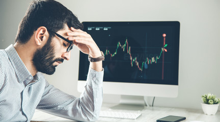 sad man with  trading computer screen background