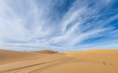 Fototapeta na wymiar Desert sand dunes ripples in blue sky, White sand dunes in Mui Ne, Vietnam.