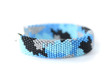 Navy blue camouflage bracelet isolated on white background close up