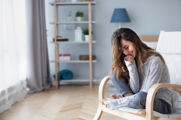 Home lifestyle woman relaxing on cozy chair in living room.