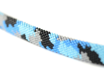 Navy blue camouflage bracelet isolated on white background close up