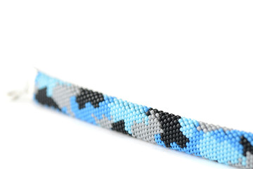 Navy blue camouflage bracelet isolated on white background close up