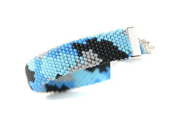 Navy blue camouflage bracelet isolated on white background close up