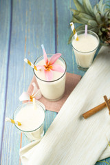Fototapeta na wymiar White Milk Yogurt Beverage On A Tropical Background