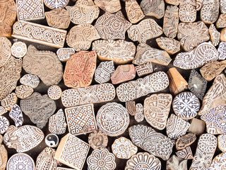 Wooden stamps printing blocks hand carved by artisans on the street market in Jaisalmer, India. Henna stamps for decorating the body or clothes.