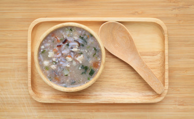 Porridge for baby food in wooden bowl