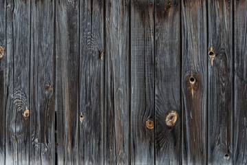 The texture of the old wooden fence dark color