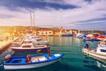 Fototapeta na wymiar Trogir boats and waterfront view, UNESCO town in Croatia landmarks. View of historic buildings and port with boats in Trogir town, Dalmatia, Croatia.
