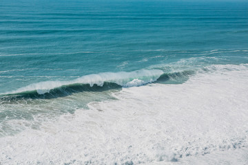 Wave and foam in the sea or ocean close-up. Beautiful nature.