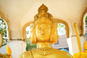 Hindu god Brahma gold shabby old statue in Thailand.