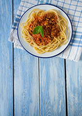spaghetti bolognese on wooden surface