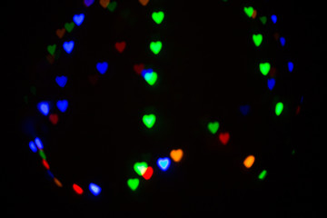 Fototapeta na wymiar Colorful abstract heart shape blured bokeh at night