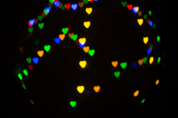 Fototapeta na wymiar Colorful abstract heart shape blured bokeh at night