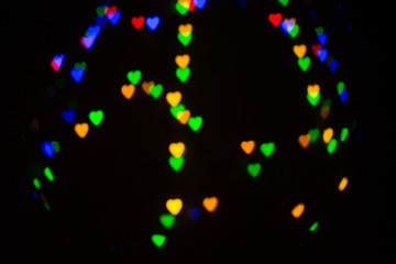 Obraz na płótnie Canvas Colorful abstract heart shape blured bokeh at night