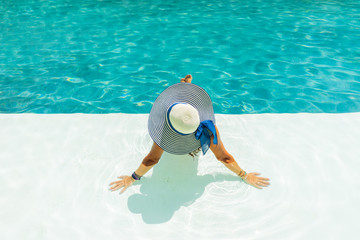 Fototapeta na wymiar Woman relaxing in swimming pool at spa resort. r