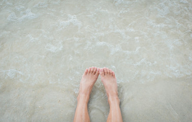 Woman leg on beach in holiday,selective focus.