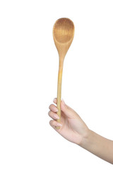 Wooden spoon in female hand