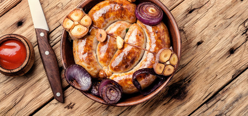 Grilled sausages on wooden board