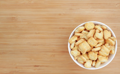 Cracker or Cookie ABC letter alphabet in white bowl on wooden background