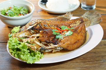 Fried fish with sweet fish sauce served with steamed rice and mango salad, Selective focus. Still life shoot in studio, Clean food good taste idea concept.