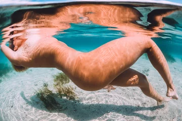 Foto op Plexiglas Nude woman swimming with starfish, underwater photo in tropical ocean © artifirsov