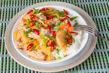 Curry of chicken and apples with rice in a bowl, top view - Asian cuisine.