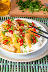 Chicken and apple curry with rice in a bowl and chopsticks, close-up - Asian cuisine.