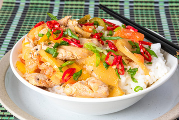 Chicken and apple curry with rice in a bowl and chopsticks, close-up - Asian cuisine.