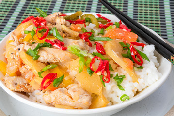 Chicken and apple curry with rice in a bowl and chopsticks, close-up - Asian cuisine.