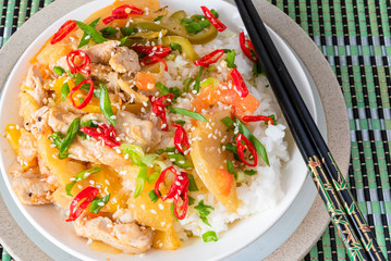 Curry chicken and apples with rice in a bowl and chopsticks, top view - Asian cuisine.