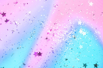 pink and blue confetti and stars and sparkles on pink background.