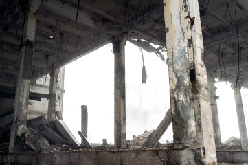 The remains of a large building destroyed in a foggy haze. Background.