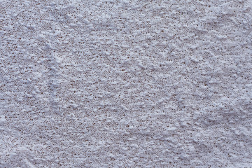 textured background of white knitted fabric top view close-up