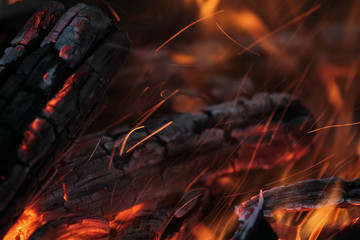 A shot of burning firewood in the fireplace. Close-up. Burning wood for a barbecue. Smoke and...