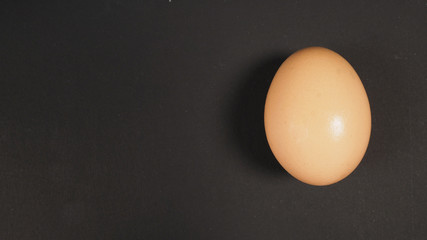 An egg is isolated ,top angle view on black background.
