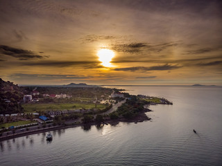 Aerial shot of Kep in Cambodia shot with a rising sun and fishing boat returning to shore.