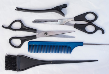 flat composition with professional hairdressing tools on white background
