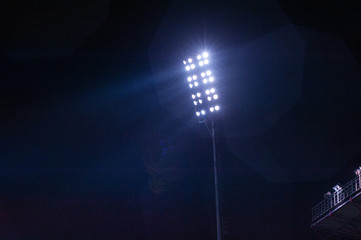 Stadium light against blue sky. High mast of spot light.