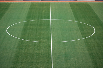 Obraz premium Aerial view of natural beautiful pattern of fresh green grass soccer field background. Football stadium.
