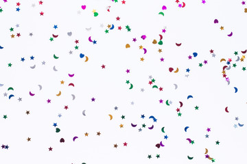 colored sequins of different shapes on white background