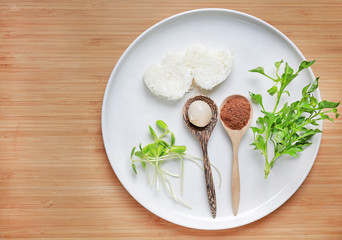 Plate of carbohydrate(rice), protein(egg and liver) and vitamin(vegetables) on wood background. Healthy baby food concept.