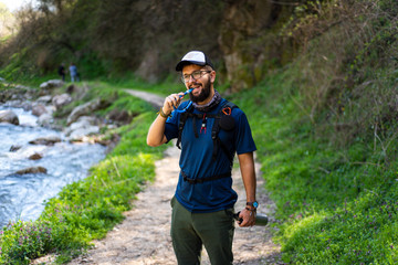 Fototapeta na wymiar Man hiking and hydrating with water pipe