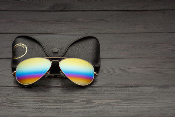 aviators sunglasses with mirrored color lenses made of glass in a gold metal frame covered with...