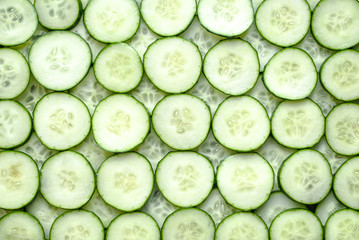 Fresh cucumber slices background.