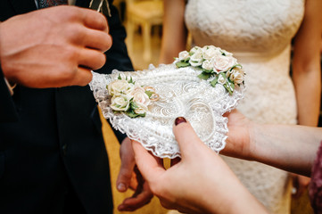 wedding rings on a heart-shaped pillow