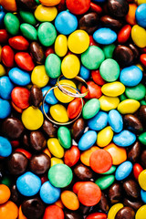 Wedding Rings on a Multicolored Sweets