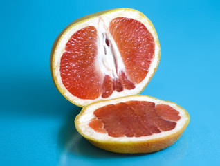Ripe grapefruit on turquoise background