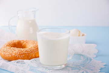 Granola with yogurt in glass on a blue table.