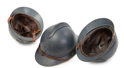 three french military helmets of the First World War on white background