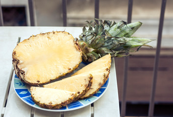 Fresh ripe pineapple on plate, vegetarian concept